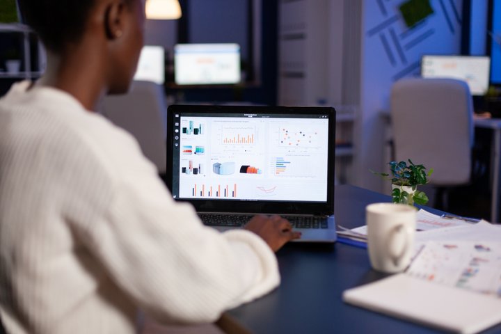 African american business entrepreneur analyzing best free HR software in 2024 and financial company graphs